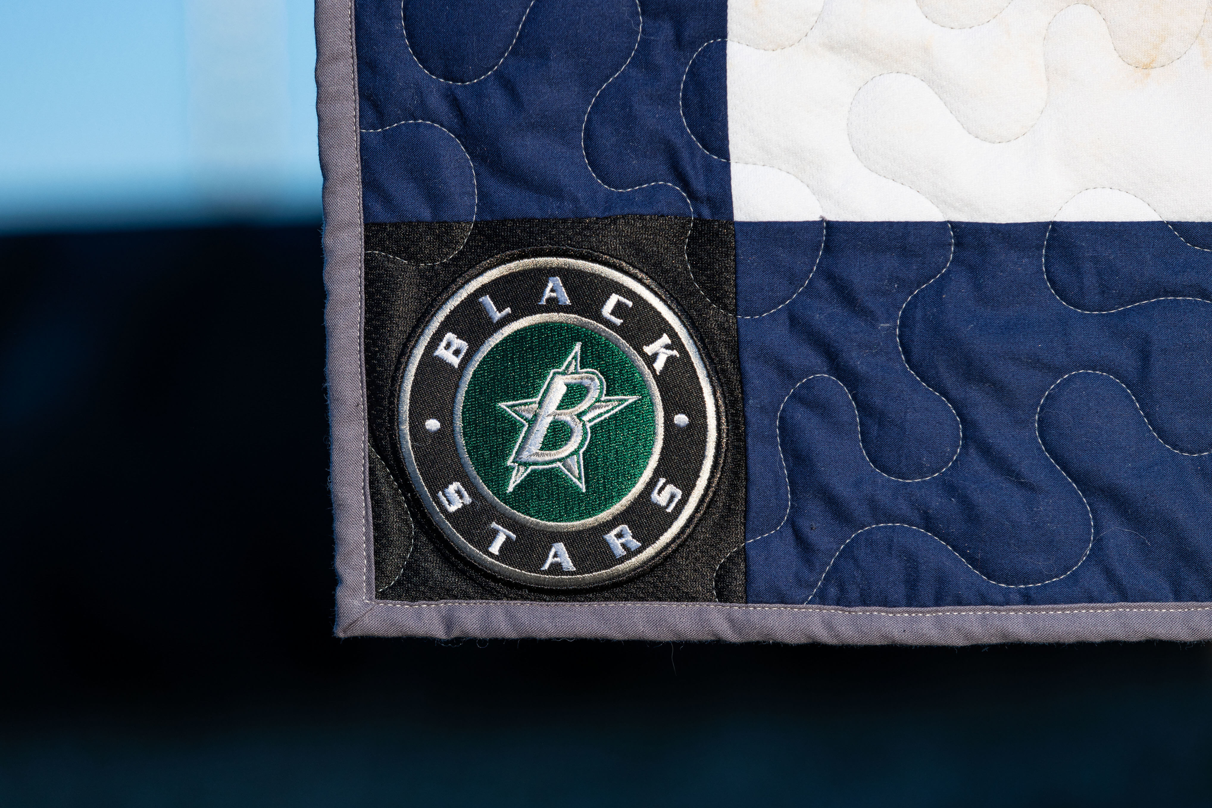 A close up photo of the custom cornerstone on a jerseyblanket